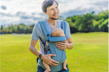 Young father walks in nature with