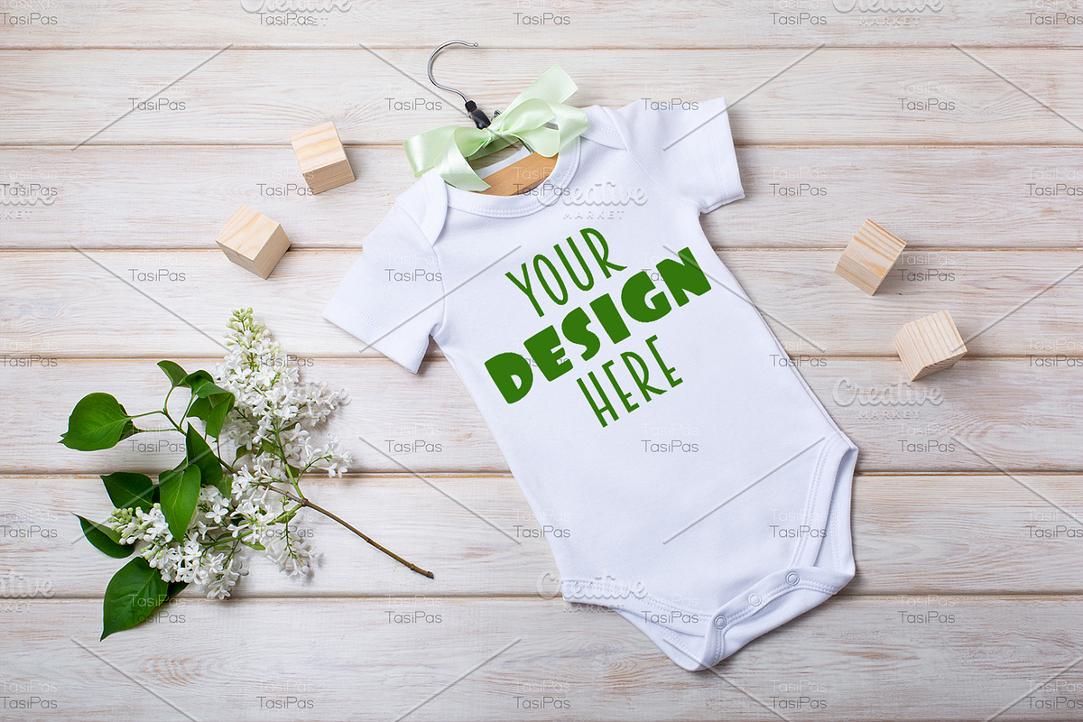 Baby onesie mockup with white lilac., a Shirt Mockup by TasiPas (Photo 1 of 4)