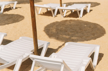 Detail of the deck chairs on a beach with parasols, a Holiday Photo by rubenchase