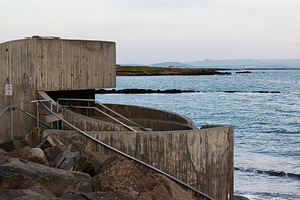 Concrete sea barrier structure along the coastline in Akranes, Iceland at sunse, a Photo by AS photostudio