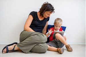 A down-syndrome school boy sitting, a Person Photo by HalfPoint