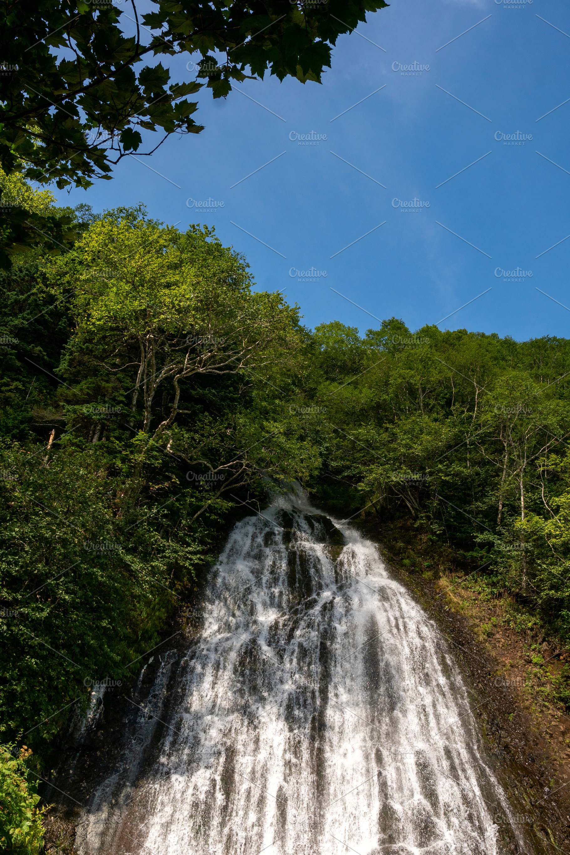 Waterfall streaming down rocky slope, a Nature Photo by Elena Vagengeim