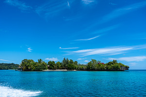 Islet surrounded by blue water, Togian Islands, Sulawesi, Indone, a Nature Photo by GoodGoods