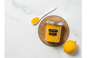 Homemade lemon curd in jar, top view, a Food & Drink Photo by Fascinadora