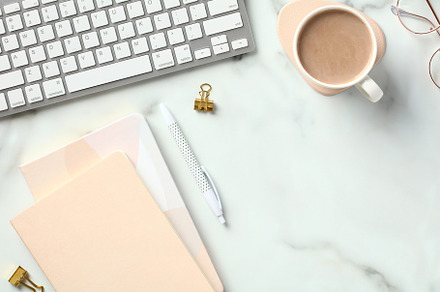 Marble office desk table with coffee cup, keyboard, paper notebook, supplies. F, a Business Photo by photoguns