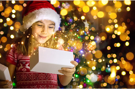 Child opens gifts under the, a Person Photo by yanadjana