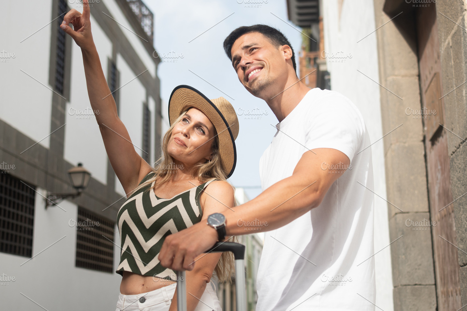 Tourist couple pointing while exploring an old town, a Person Photo by etorres69
