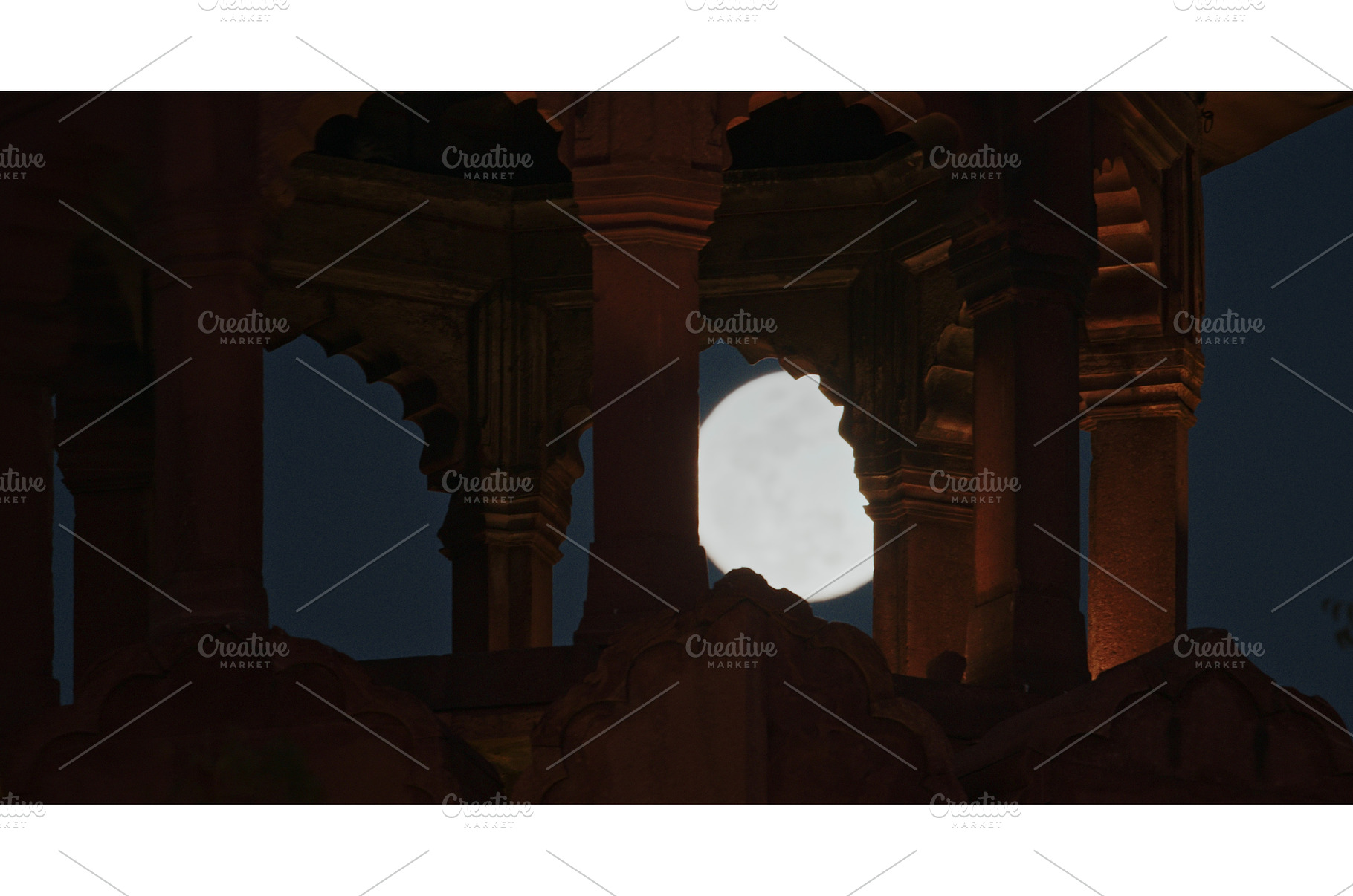 Full moon framed by arches of, an Architecture Photo by Our Amazing World