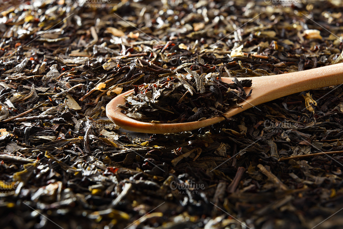 Wooden spoon filled with tea leaves on background of tea, a Food & Drink Photo by Davizro's Market (Photo 1 of 2)