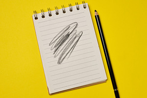 Spiral-bound lined notepad with a black pencil and a scribbled d, a Business Photo by ndanko