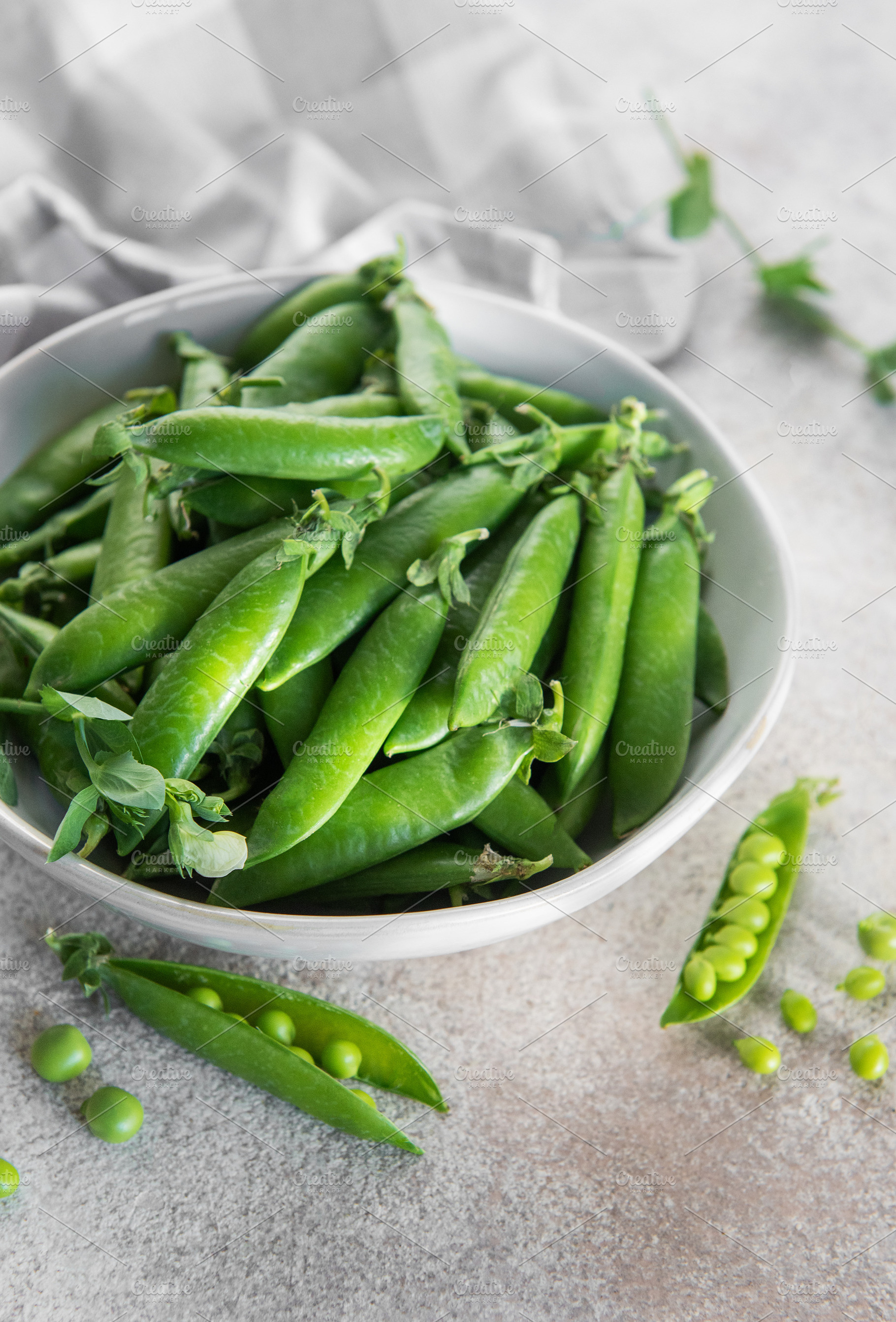 Fresh green peas pods in white bowl, a Food & Drink Photo by Olena Rudo