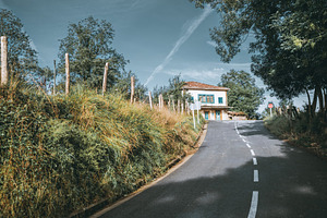 Rural road to blue-shutter house, an Architecture Photo by SkyNext