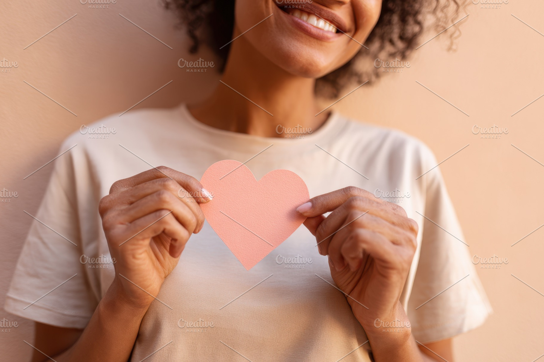 Woman holding a paper heart on pastel background, a Person Photo by AlyaAnd
