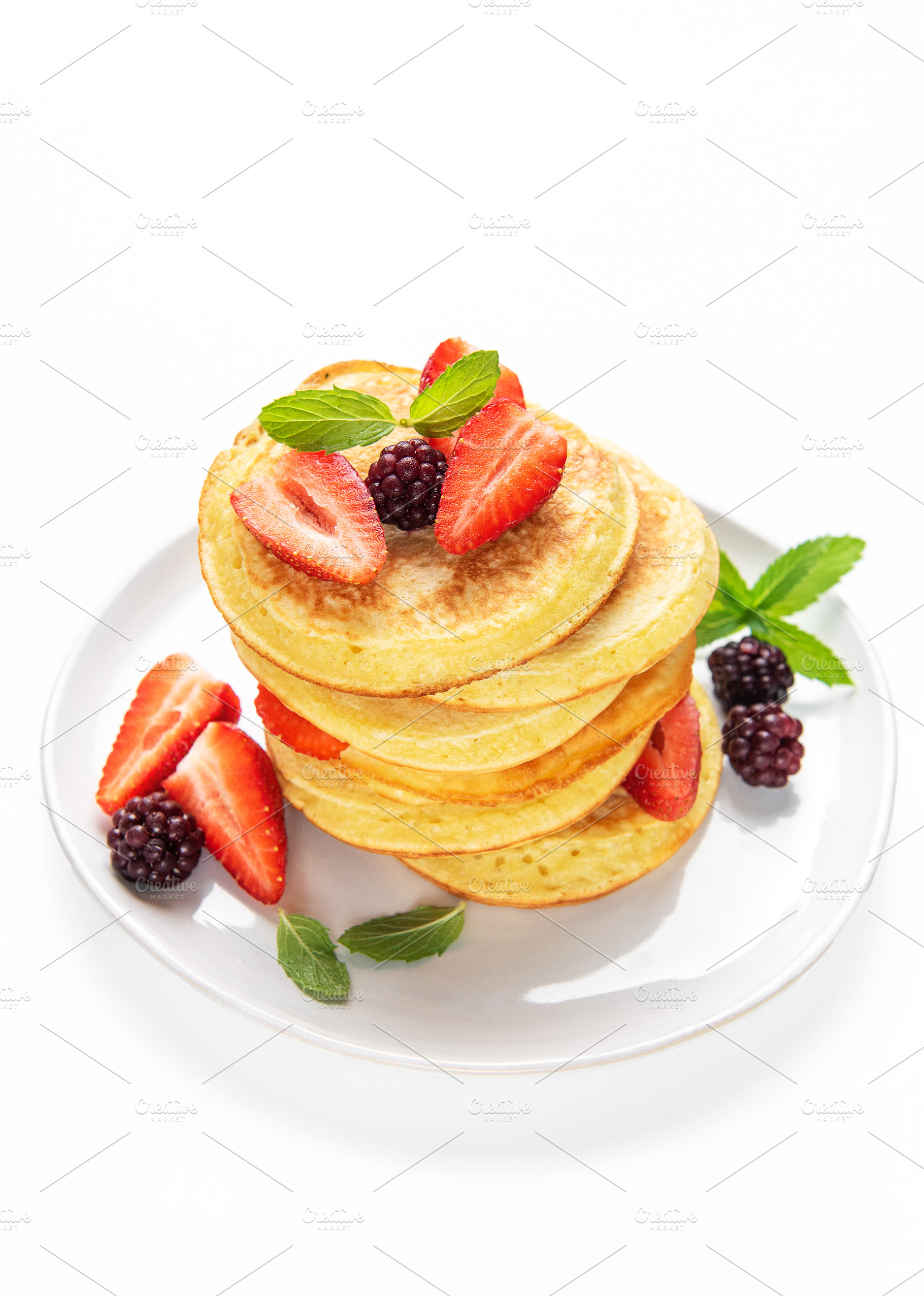 Pancakes stacking with strawberries, blackberries, and mint, a Food & Drink Photo by Olena Rudo