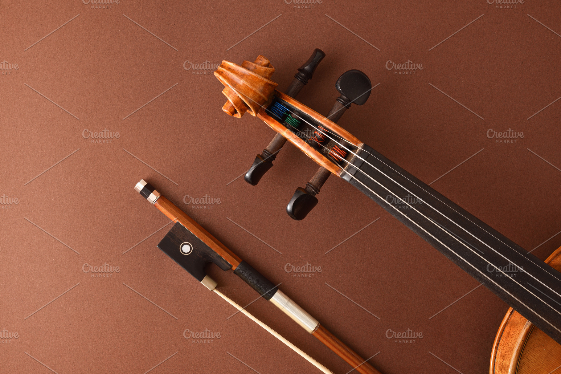 Peg box and fingerboard of violin and bow on brown, an Arts & Entertainment Photo by Davizro's Market