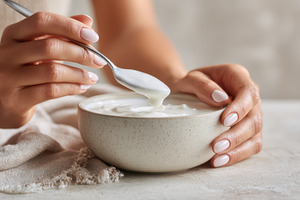 Person eating yogurt with a spoon, a Photo by Beautiful things