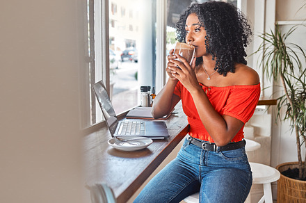 Coffee shop, thinking and black woman drinking her coffee and looking out window. Student working with laptop in cafe, taking a break to drink hot chocolate, think and brainstorm ideas for project, a Photo by Peopleimages.com