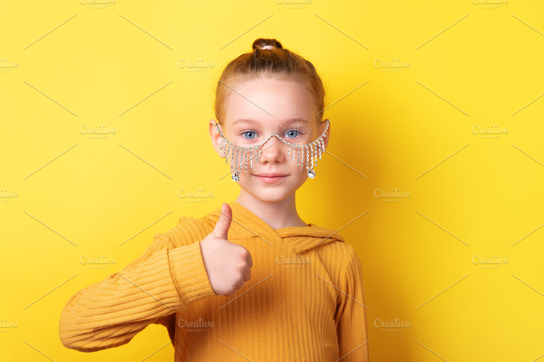 Smiling young girl in stylish glasses giving a thumbs up against, a Person Photo by Ales Munt