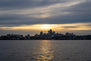 Sydney skyline at sunset with golden reflections on the water, a Nature Photo by GoodGoods