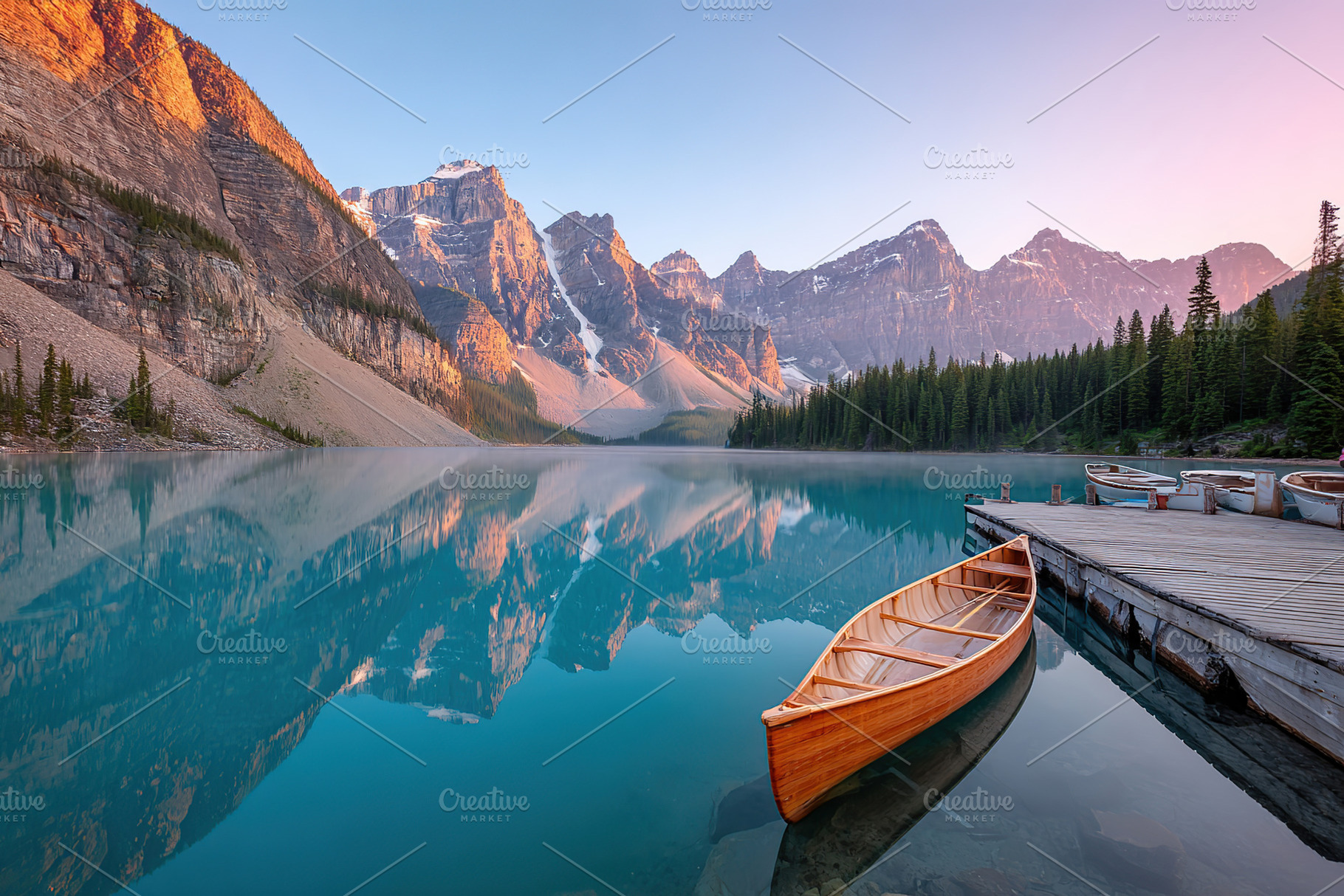 Serene morning at glacial lake with wooden canoe and mountain reflections, a Photo by AlyaAnd