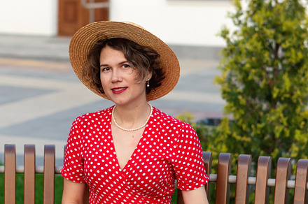 Smiling woman in red wrap dress