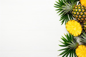 Ripe sliced pineapples on white background, a Food & Drink Photo by AlyaAnd