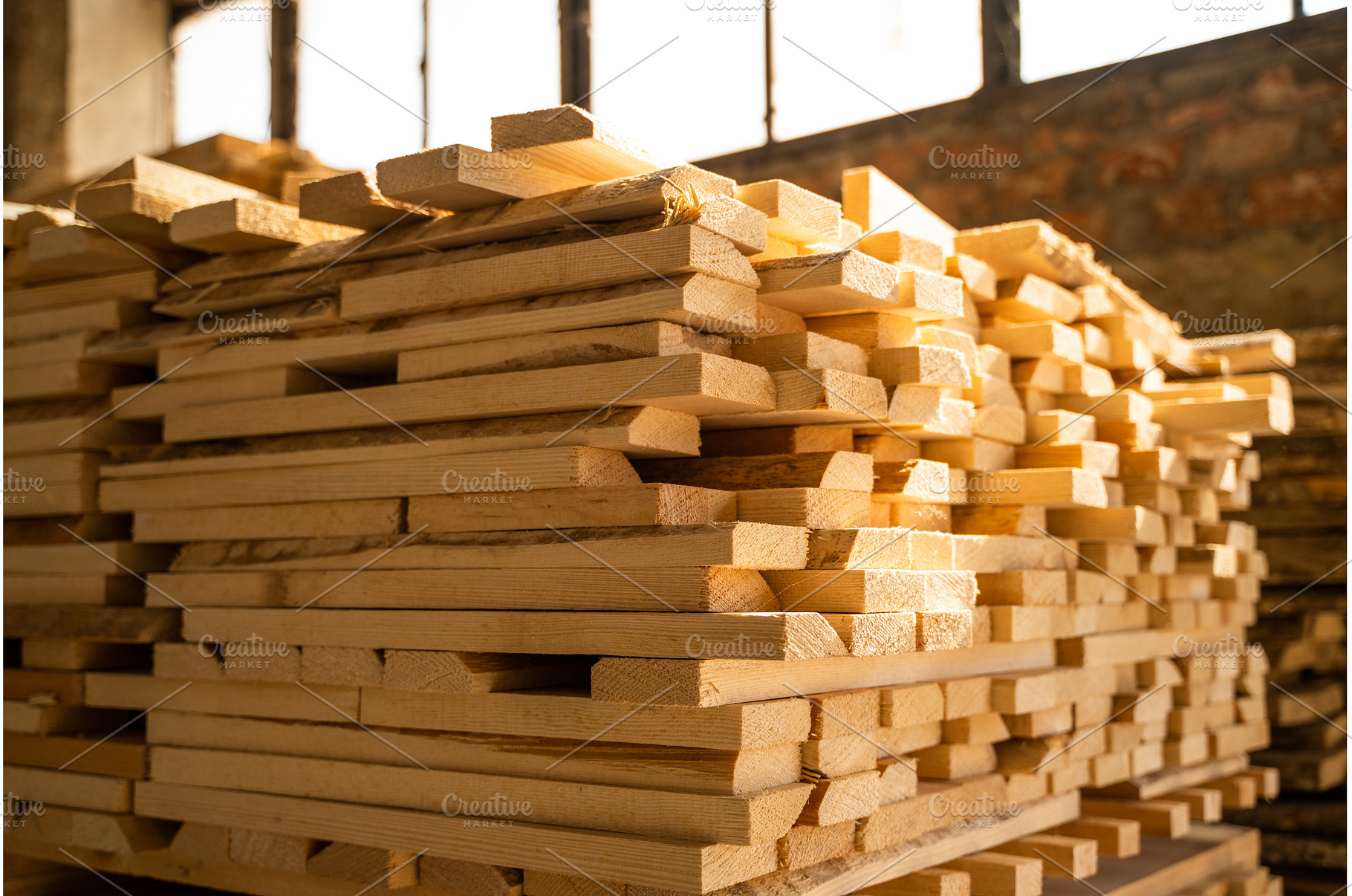 Sunlit stack of timber boards in, an Industrial Photo by volodymyrshtun13795