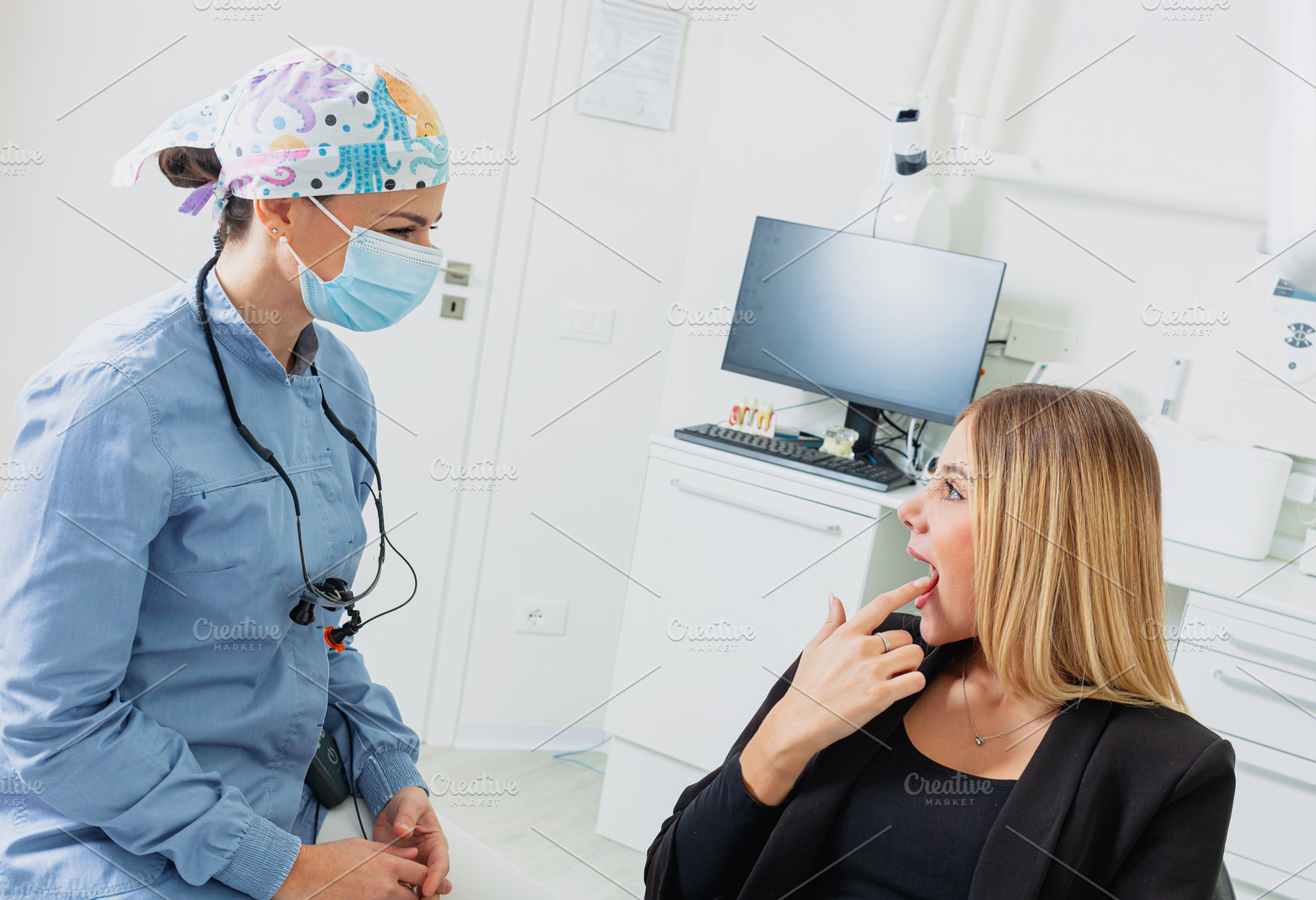 Dentist wearing surgical mask examining patient's teeth in dental clinic, a Health & Medical Photo by Antonio Gravante Market
