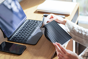 Designer choosing material swatches at home office workspace, a Business Photo by Olena Rudo