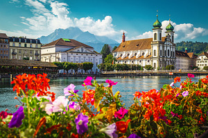 Flowery river side in Lucerne, an Architecture Photo by Alpine Dreams
