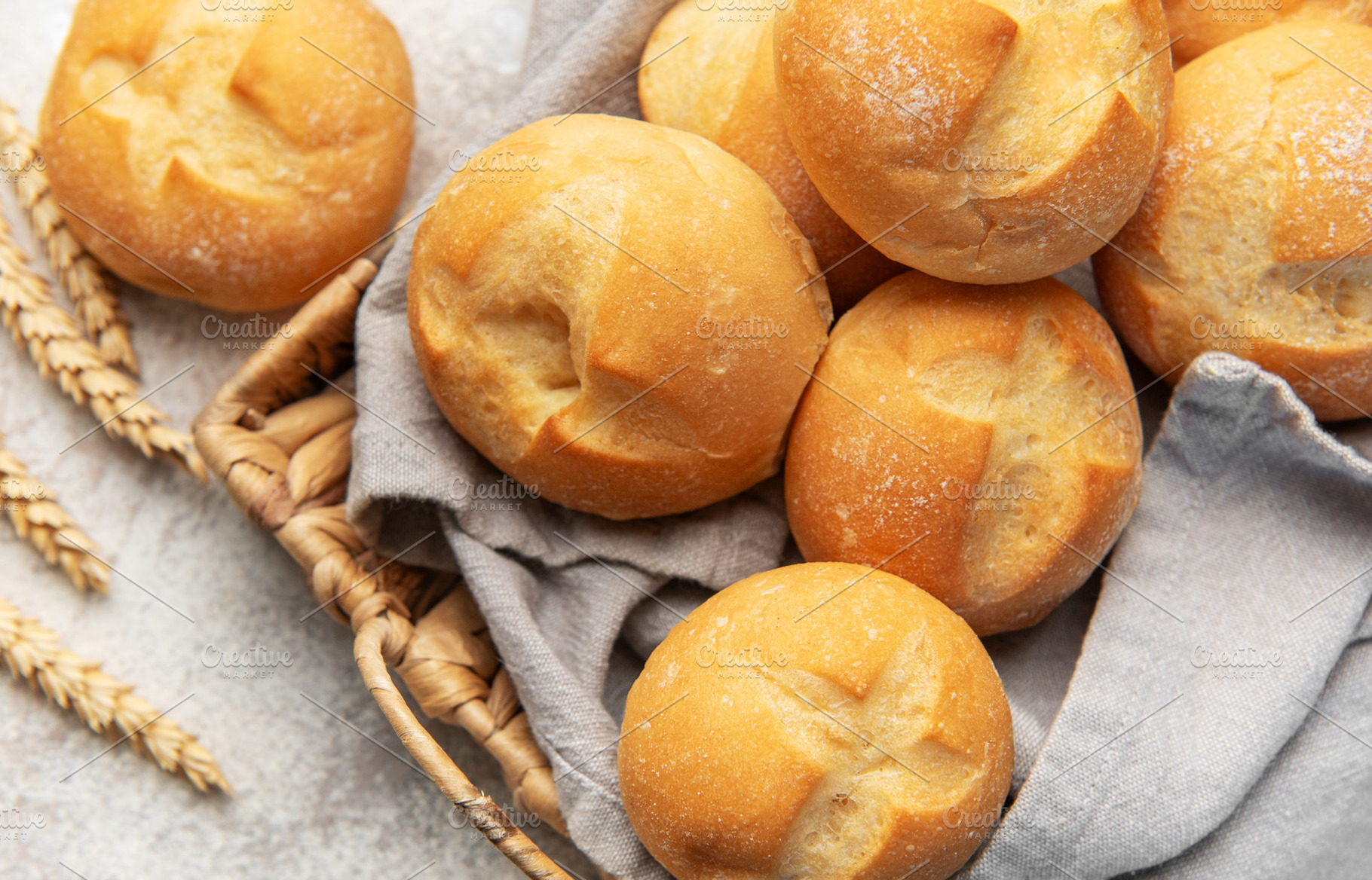 Freshly baked bread rolls in a woven basket, a Food & Drink Photo by Olena Rudo