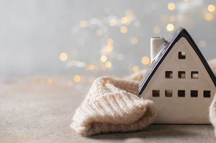Ceramic house insulated by warm sweater. Concept of protection of house and lac, a Holiday Photo by Anikona