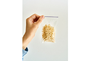 Hand holding ziplock bag with cooked, a Food & Drink Photo by Gladkov photography