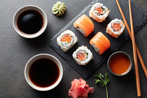 Delicious sushi platter with assorted rolls and sauces, a Food & Drink Photo by AlyaAnd