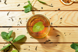 Green tea in the center of wooden table with leaves, a Food & Drink Photo by Davizro's Market