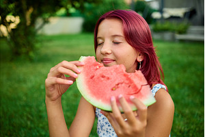 Girl enjoys a slice of watermelon, a Food & Drink Photo by IlliaBondarPhotography