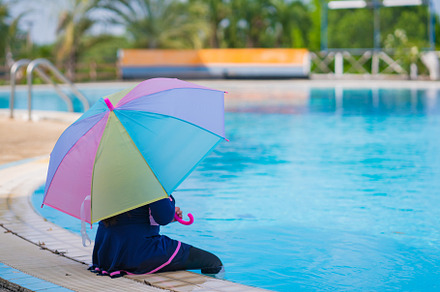 little girl smiling near in swimming pool and holding colourful, a Sports & Recreation Photo by Casanowe-studio