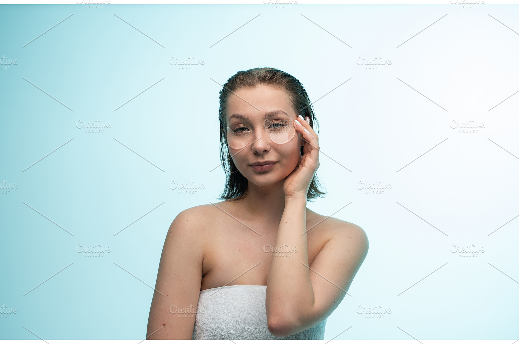 Young woman applying under eye, a Health & Medical Photo by volodymyrshtun13795