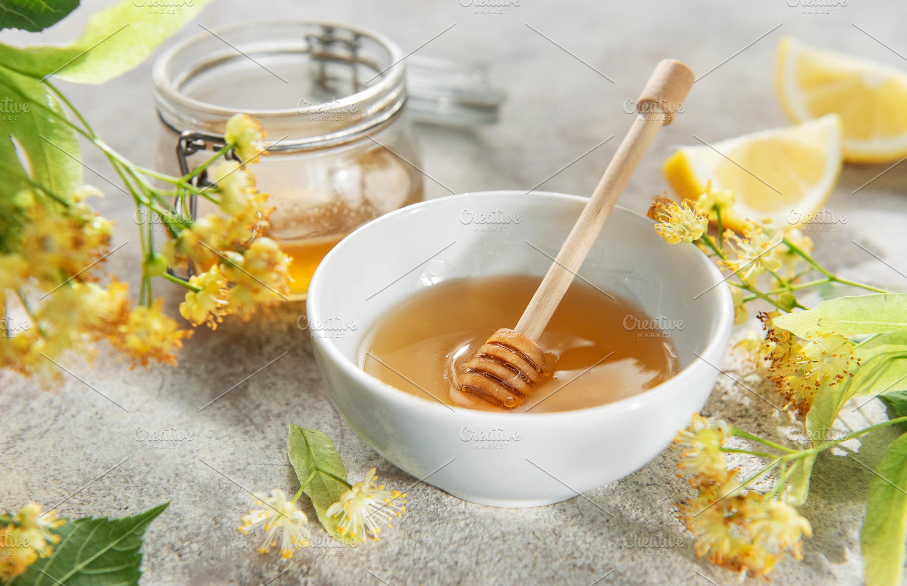 Honey in bowl with dipper and linden flowers, a Food & Drink Photo by Olena Rudo