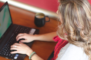 Woman using a laptop in coffee shop