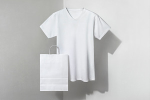 white v-neck t-shirt and paper bag