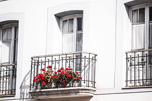 Vintage balcony with red flowers, an Architecture Photo by SkyNext