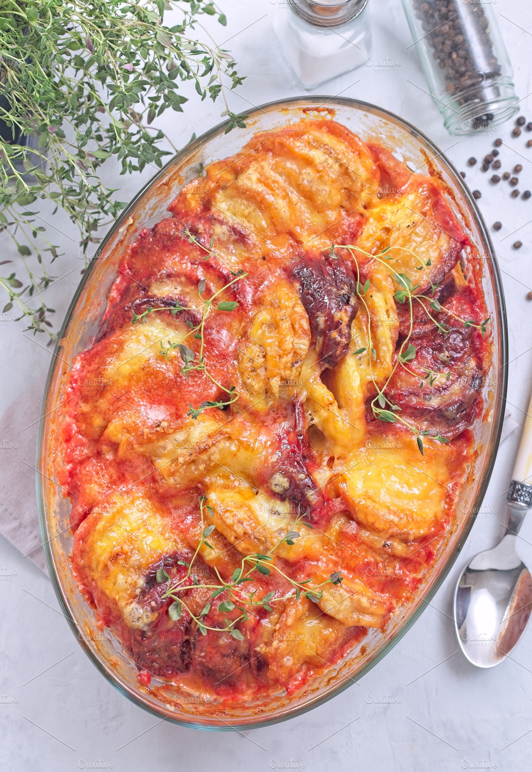 Gratin with sweet potato, parsnips, beet root and melted cheese, in glass dish,, a Food & Drink Photo by iuliia_n
