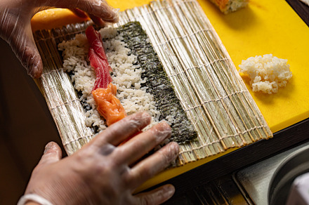 Chef preparing sushi rolls