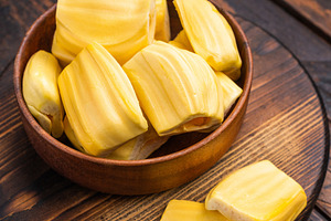 Sweet, golden jackfruit pods (bulbs) in a wooden bowl on a rusti, a Photo by composter-box@mail.ru