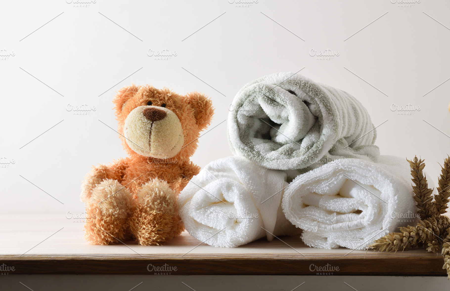 Towels and bathrobe on cabinet with teddy white isolated backgro, a Health & Medical Photo by Davizro's Market