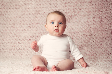 Newborn baby girl with white bodysui