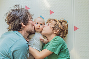 Father, son, and newborn baby lying, a Person Photo by Elizaveta Galitskaya