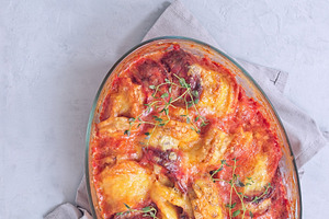 Gratin with sweet potato, parsnips, beet root and melted cheese, in glass dish,, a Food & Drink Photo by iuliia_n