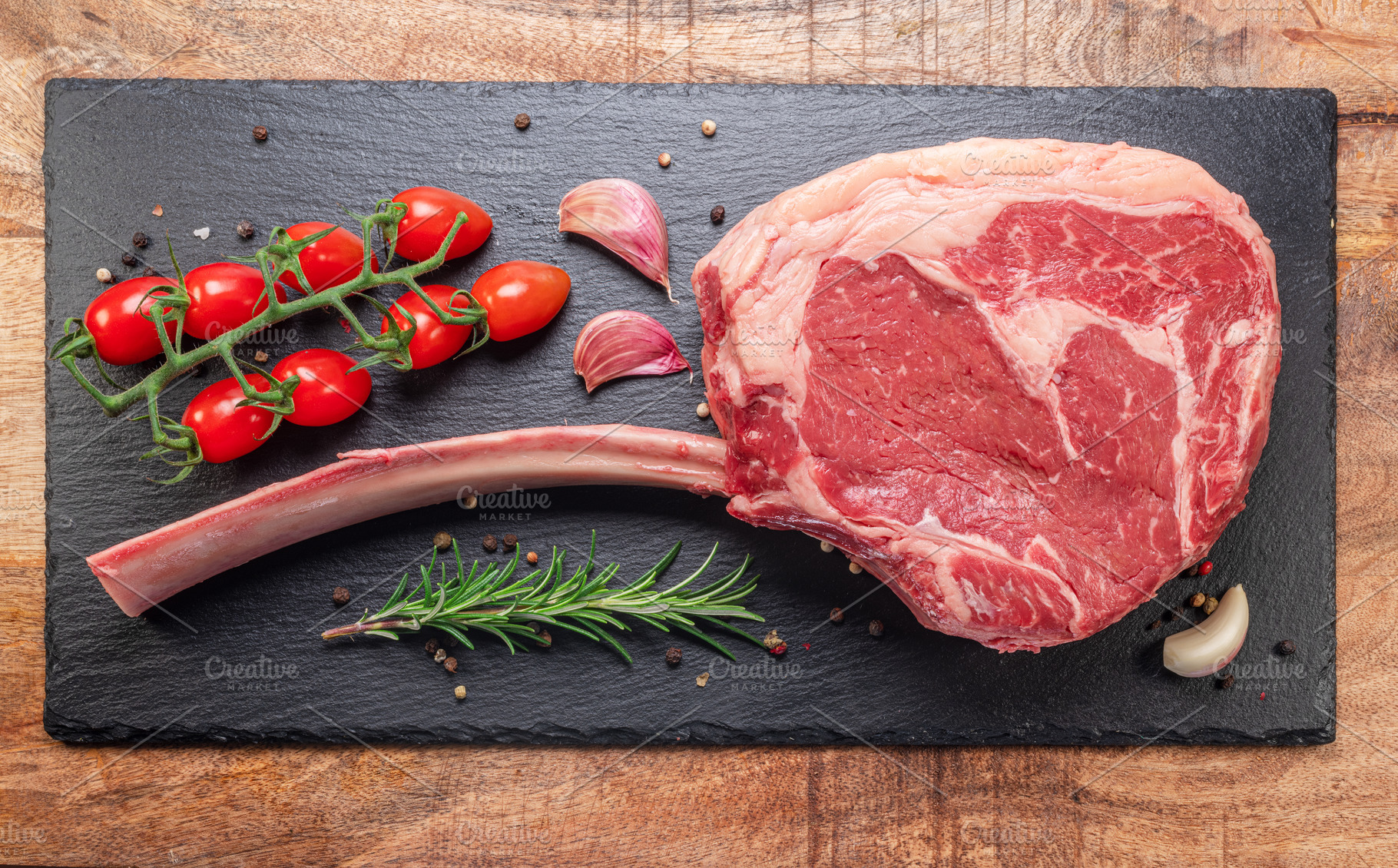 Raw rib steak with bone or tomahawk steak with seasonings on sla, a Food & Drink Photo by Volff